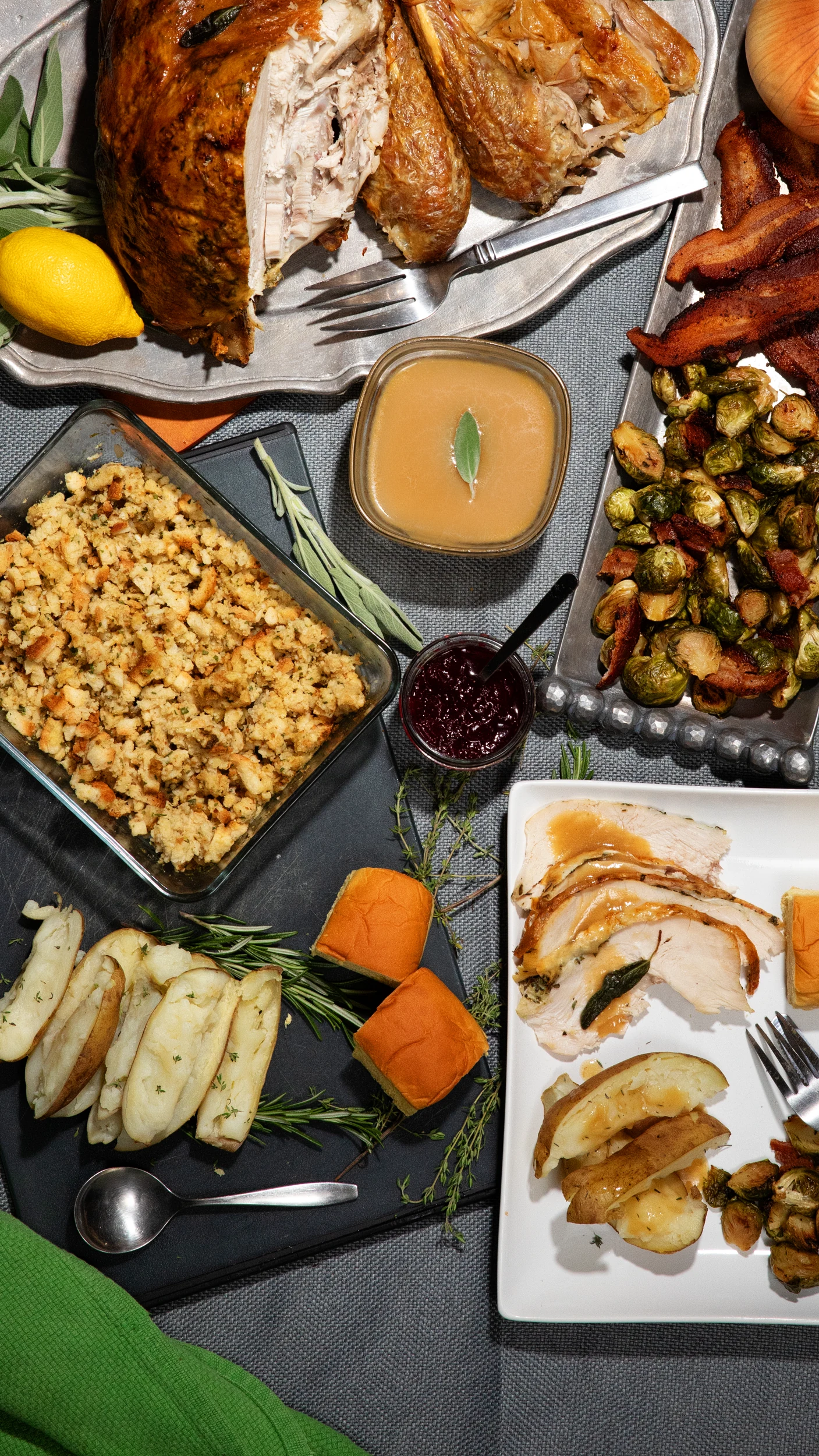 Roast turkey, gravy, stuffing and vegetables on a Thanksgiving table